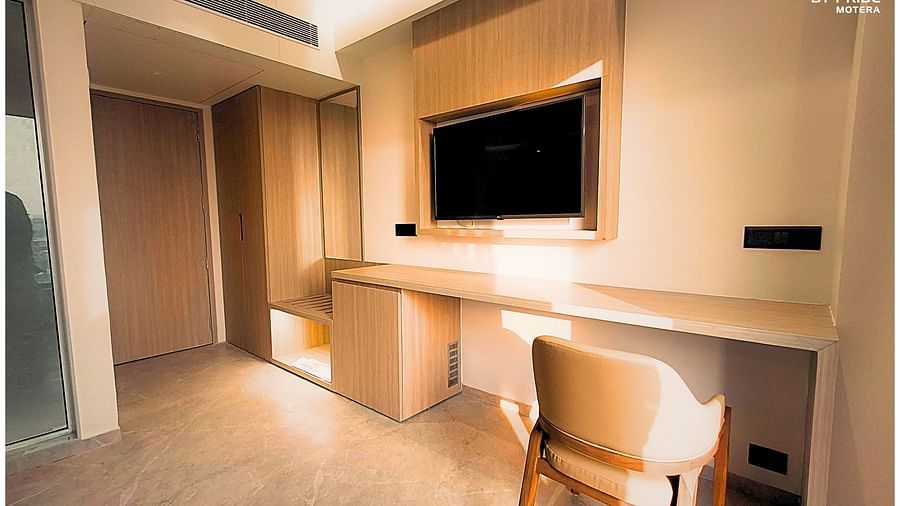 image featuring the work desk with a chair along with a wall mounted television - biznotel by pride, motera